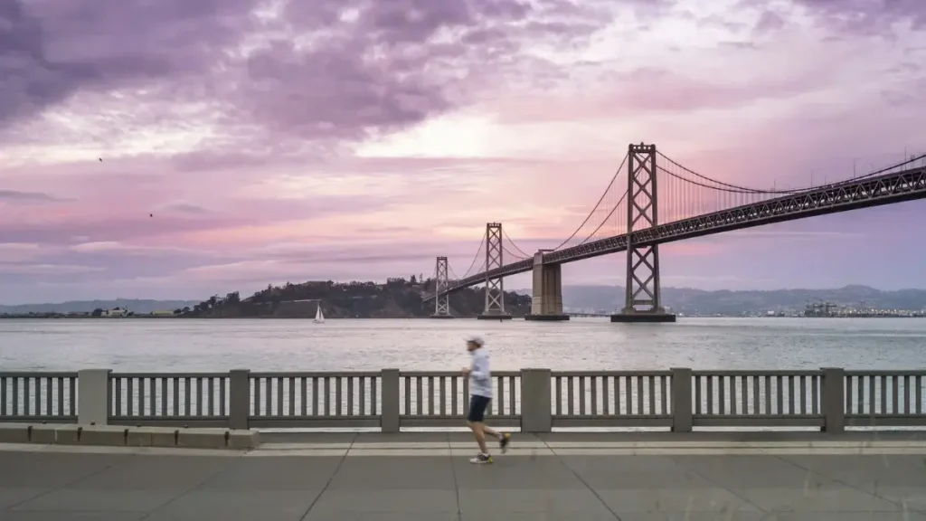 Runner next to the San Francisco Bay Bridge.