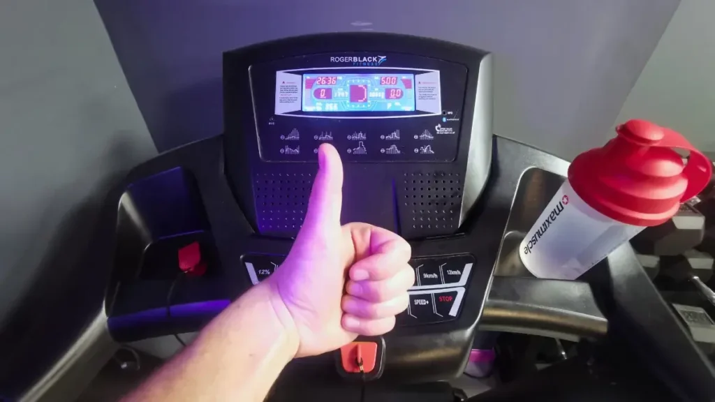 marathon training on treadmill with a thumbs up pose