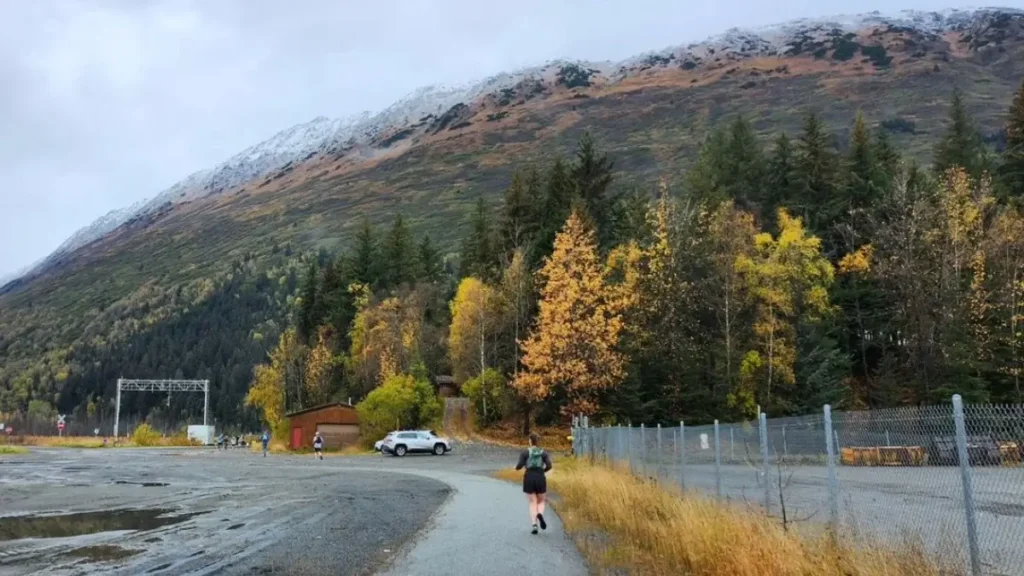 A runner is dwarfed by a snowy mountain at the Girdwood Marathon near Anchorage.