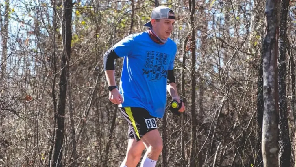 A runner tackles a steep hill through the forest at the Athens Big Fork Marathon in Big Fork.