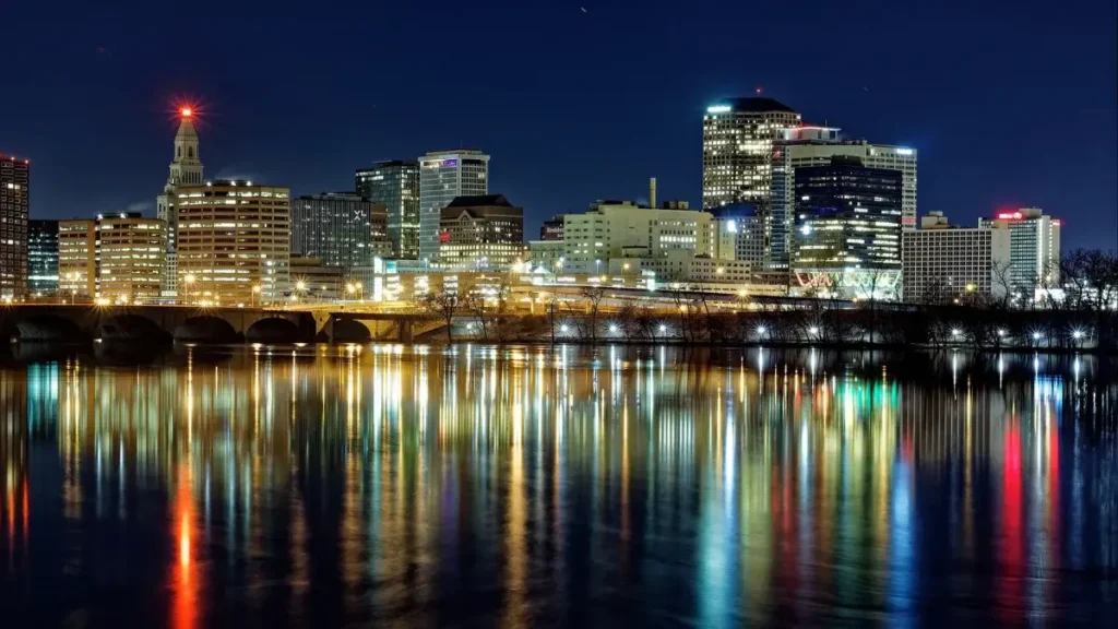 The Hartford, Connecticut skyline illuminated against the night sky.