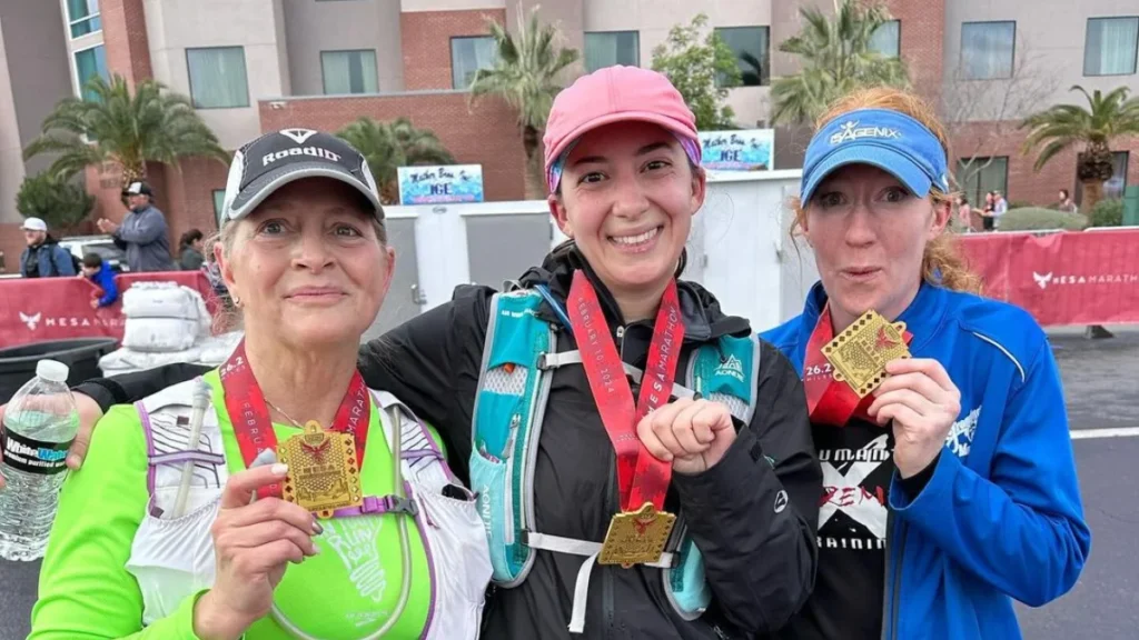 Three finishers proudly display their medals at the Mesa Marathon in Mesa.