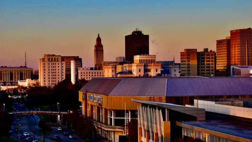 Downtown Baton Rouge skyline at sunset, featuring the Raising Cane's River Center near the Louisiana Marathon route.